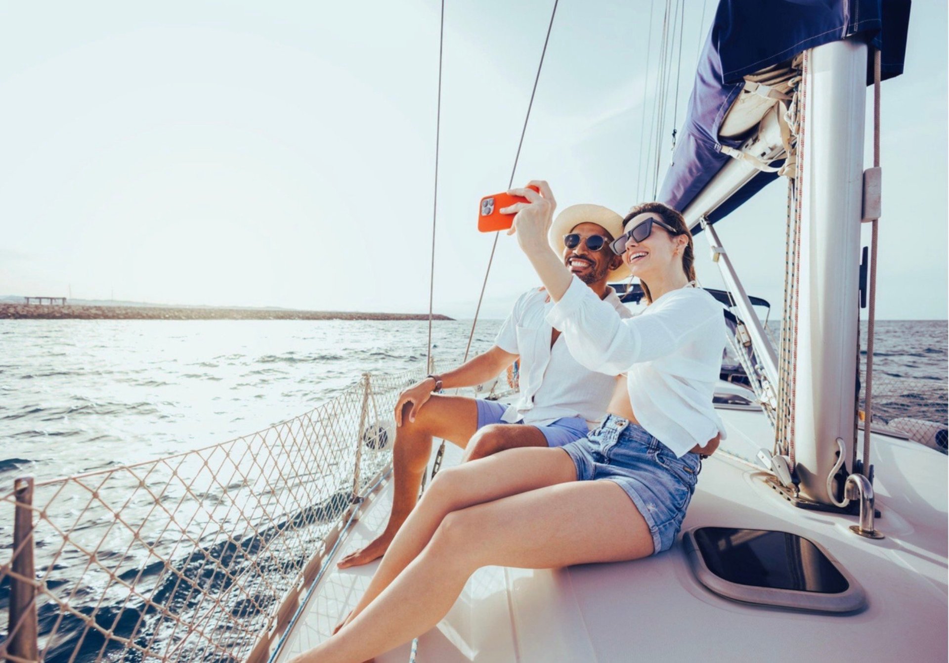 Two people on a sailboat enjoying lifestyle